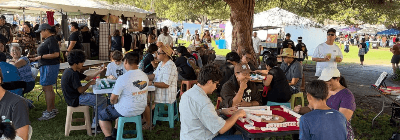 Community members playing Filipino Mahjong at an outdoor social event